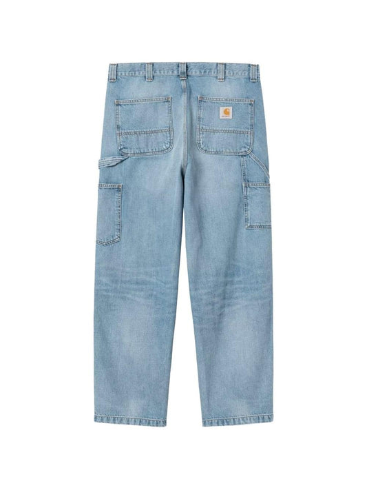 Carhartt Wip Main denim cotton jeans displayed on a hanger, showcasing classic fit and durable fabric with visible stitching details.