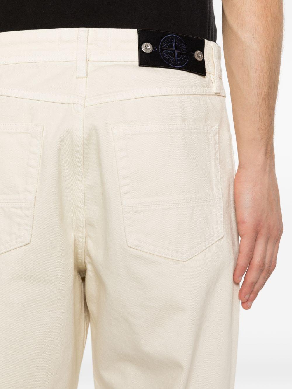 Stone Island Denim cotton jeans showing classic five-pocket design and Stone Island branding on the back pocket.