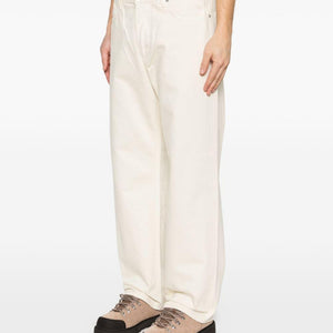 Stone Island denim cotton jeans with classic five-pocket design and signature branding, displayed on a neutral background.
