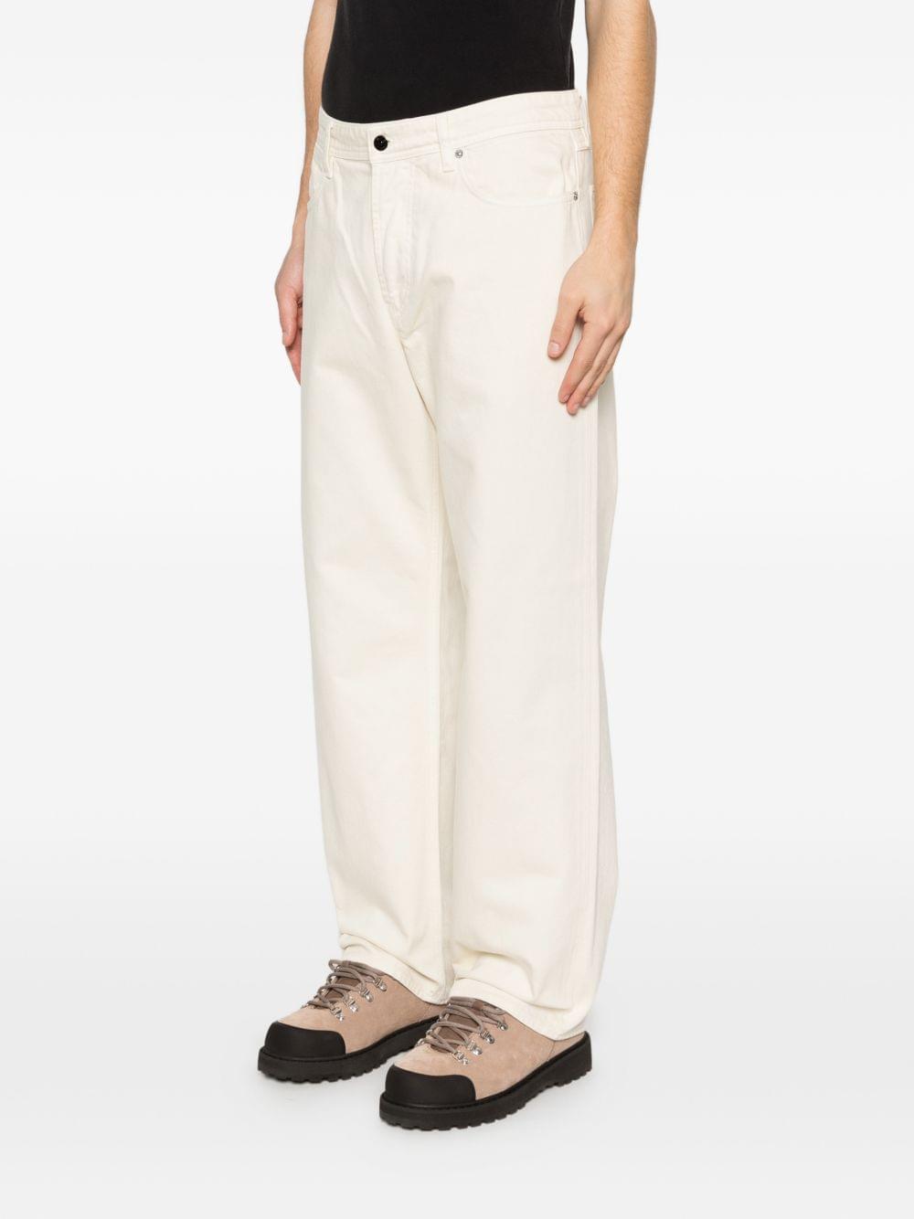 Stone Island denim cotton jeans with classic five-pocket design and signature branding, displayed on a neutral background.