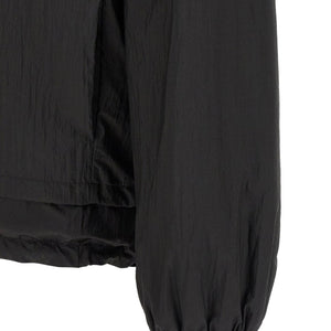Fendi reversible windbreaker jacket in black and beige with logo accents, shown with open and closed views.