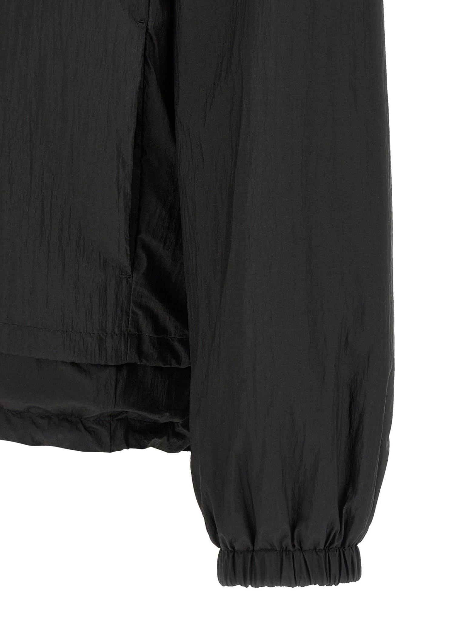 Fendi reversible windbreaker jacket in black and beige with logo accents, shown with open and closed views.