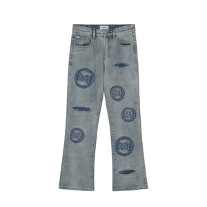 Blue distressed embroidered jeans by LUXENK, showcasing a relaxed fit and detailed embroidery on the fabric.
