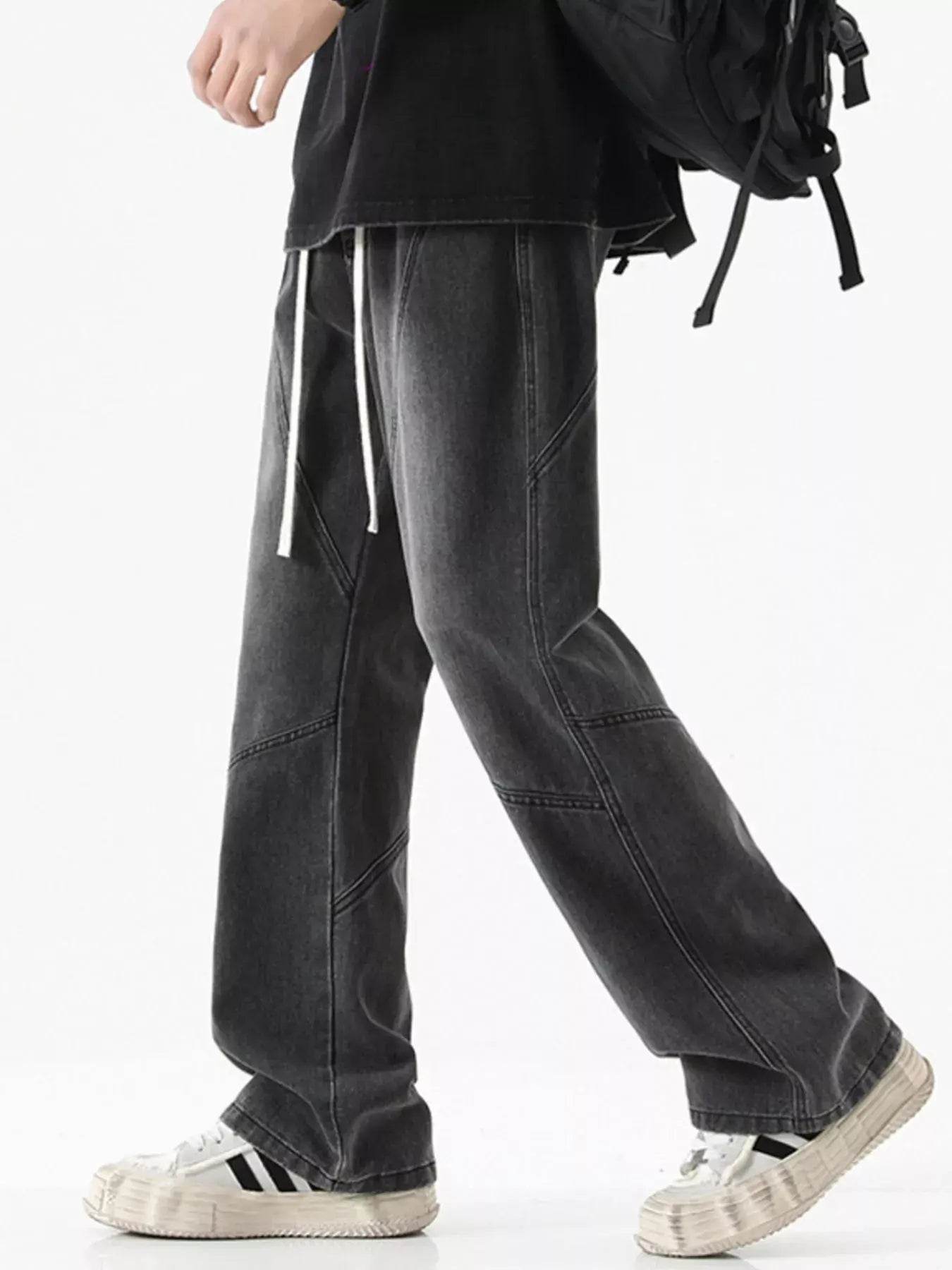 Black LUXENK© Drawstring Wide Leg Jeans by Trendsi, featuring a relaxed fit and adjustable waist, shown on a model.