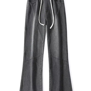 Black LUXENK© Drawstring Wide Leg Jeans by Trendsi, featuring a relaxed fit and adjustable waist, shown on a model.