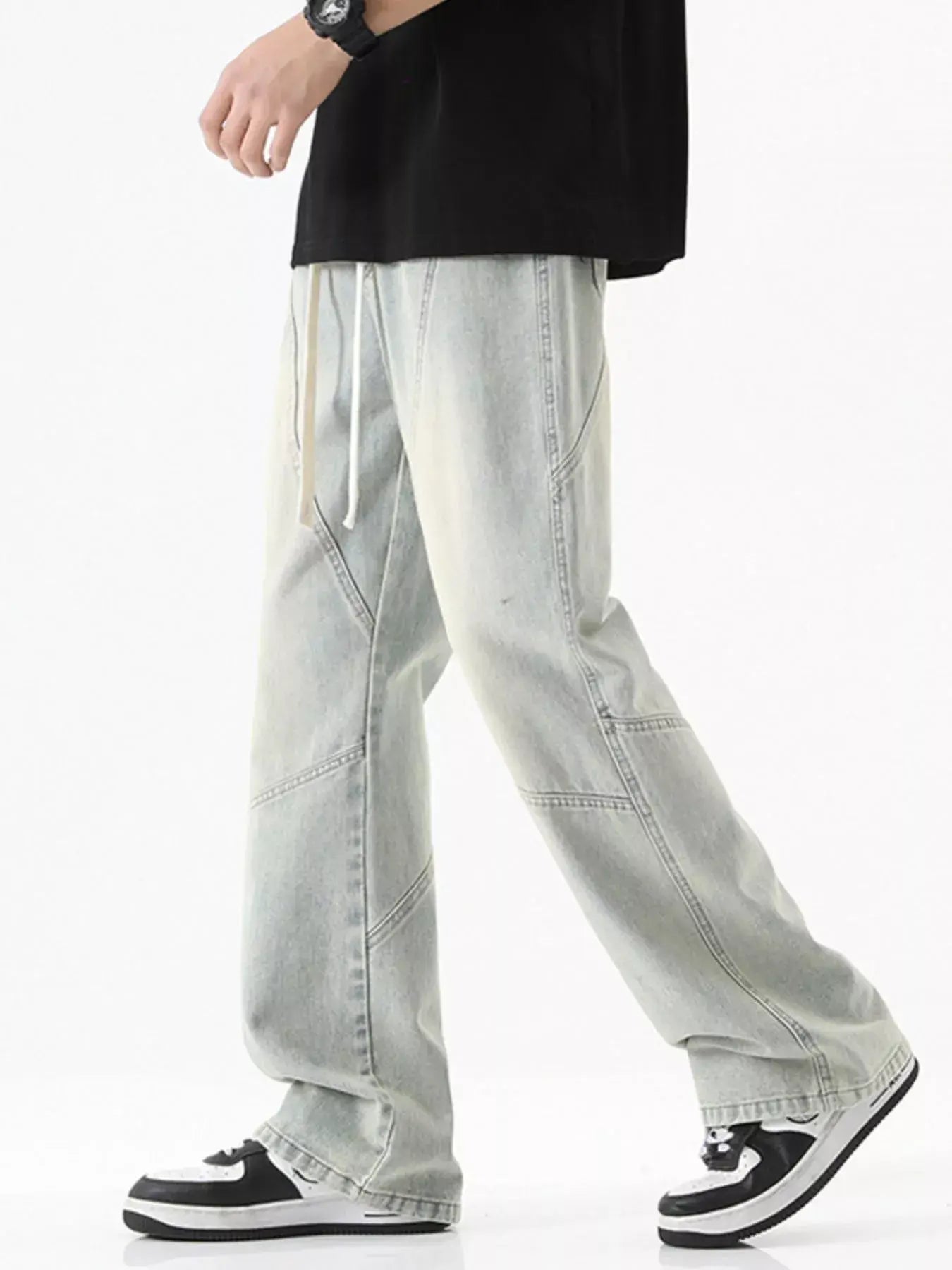 Black Luxenk Drawstring Wide Leg Jeans by Trendsi, featuring a relaxed fit and casual style with a drawstring waist and wide legs.