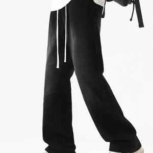 Black Luxenk© drawstring wide-leg jeans from Trendsi, featuring a relaxed fit and casual style with visible waistband and stitching details.