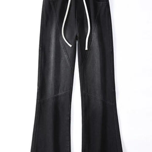 Black Luxenk© Drawstring Wide Leg Jeans by Trendsi featuring a relaxed fit, high waist, and casual style, shown on a model.