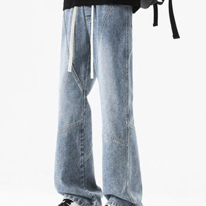 Black LUXENK Drawstring Wide Leg Jeans by Trendsi featuring a relaxed fit and adjustable waistband, displayed on a model.