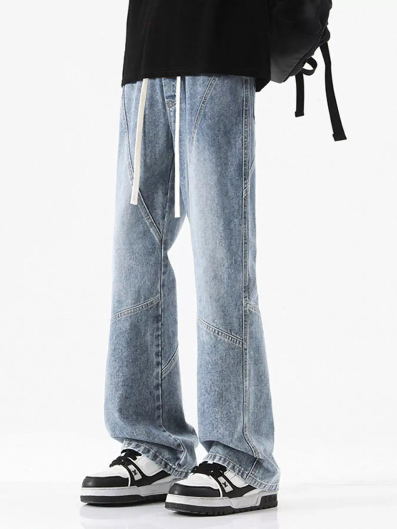 Black LUXENK Drawstring Wide Leg Jeans by Trendsi featuring a relaxed fit and adjustable waistband, displayed on a model.
