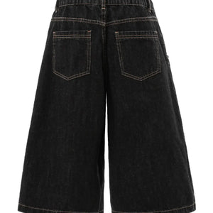 Black Luxenk Plaid Accent Denim Shorts with frayed hem and high-waisted fit, styled with casual accessories.