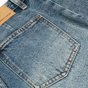 Blue washed denim shorts by Luxenk, featuring a casual fit and raw hem, perfect for summer wear.