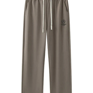 Caramel-colored Luxenk© drawstring sweatpants with elastic waistband and relaxed fit, shown on a model.