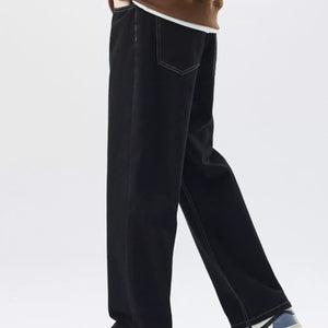 Trendsi LUXENK Plus Wide Leg Jeans in classic black, featuring a relaxed fit and high-rise waist, shown on a model.
