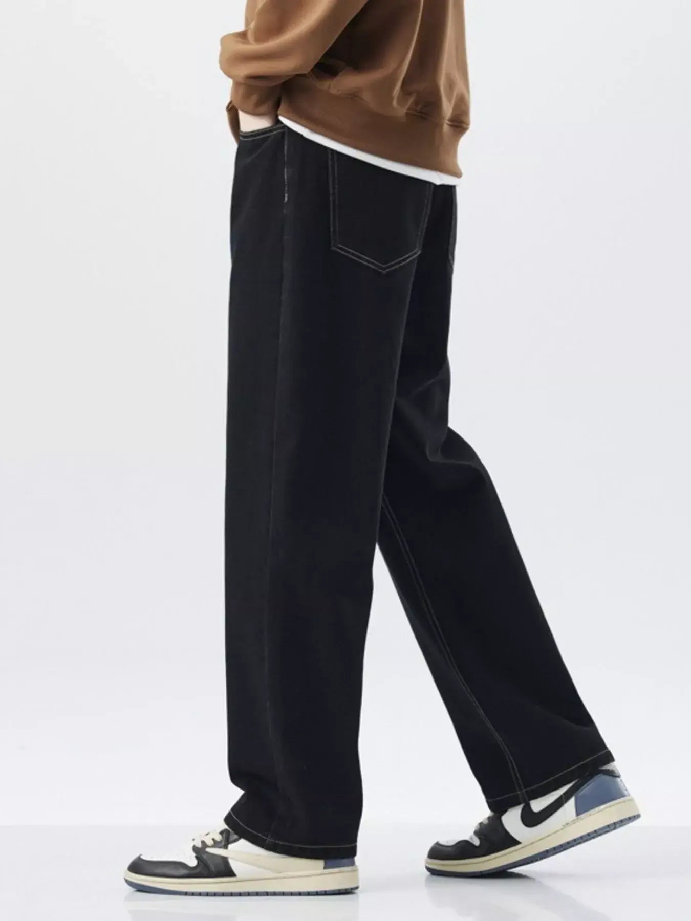 Trendsi LUXENK Plus Wide Leg Jeans in classic black, featuring a relaxed fit and high-rise waist, shown on a model.