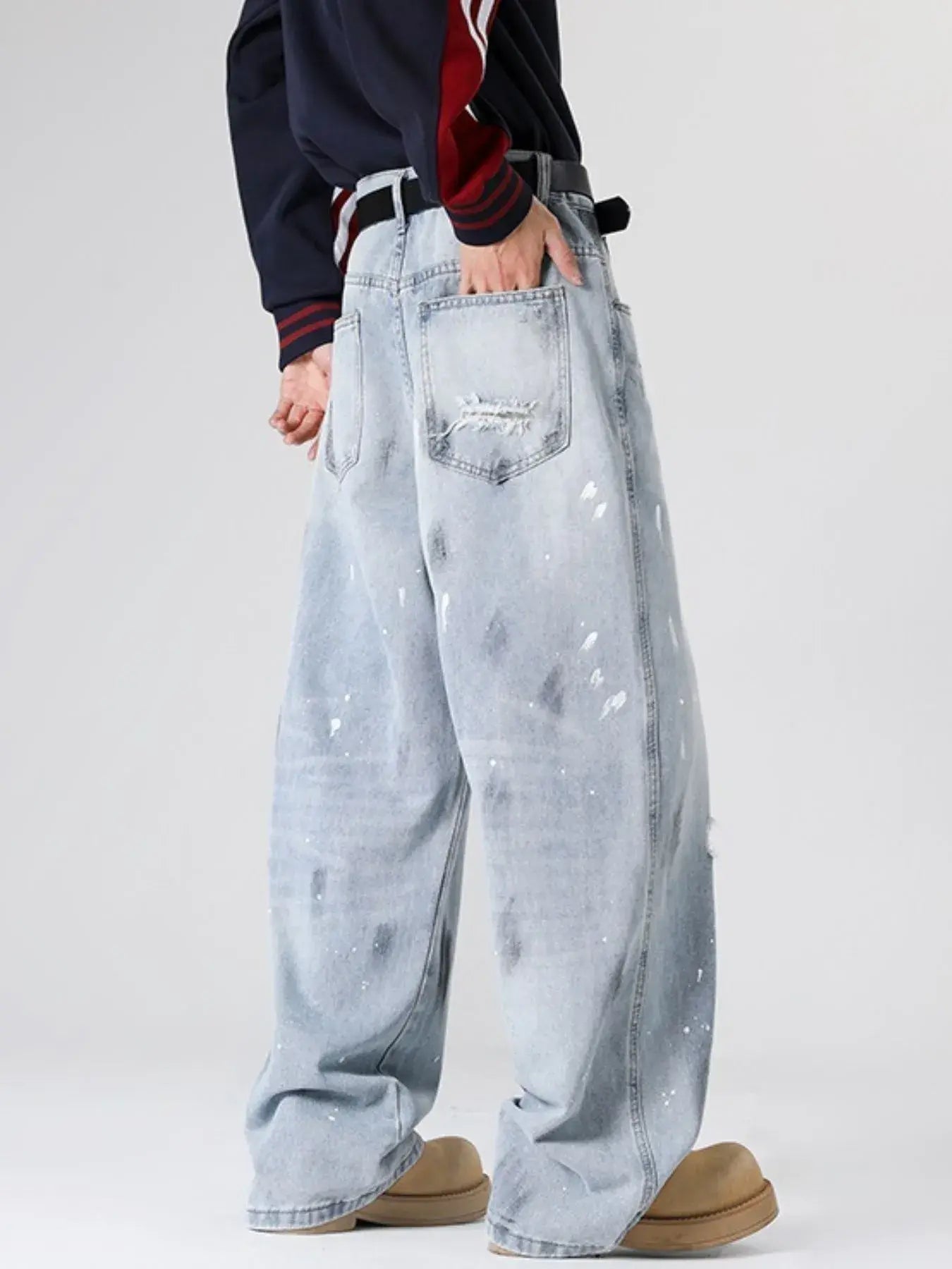 Light blue distressed wide-leg jeans by Luxenk©, featuring a relaxed fit and stylish worn-in details.