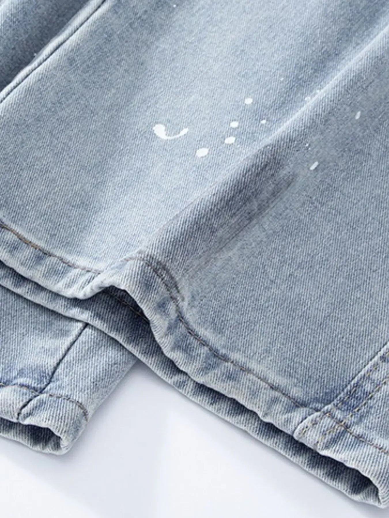 Light blue Luxenk© distressed wide-leg jeans with a relaxed fit and ruffled details, styled by Trendsi.