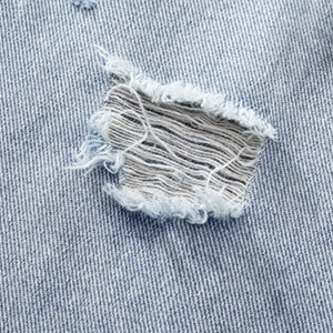 Light blue Luxenk distressed wide-leg jeans by Trendsi, featuring a relaxed fit and stylish ripped detailing.
