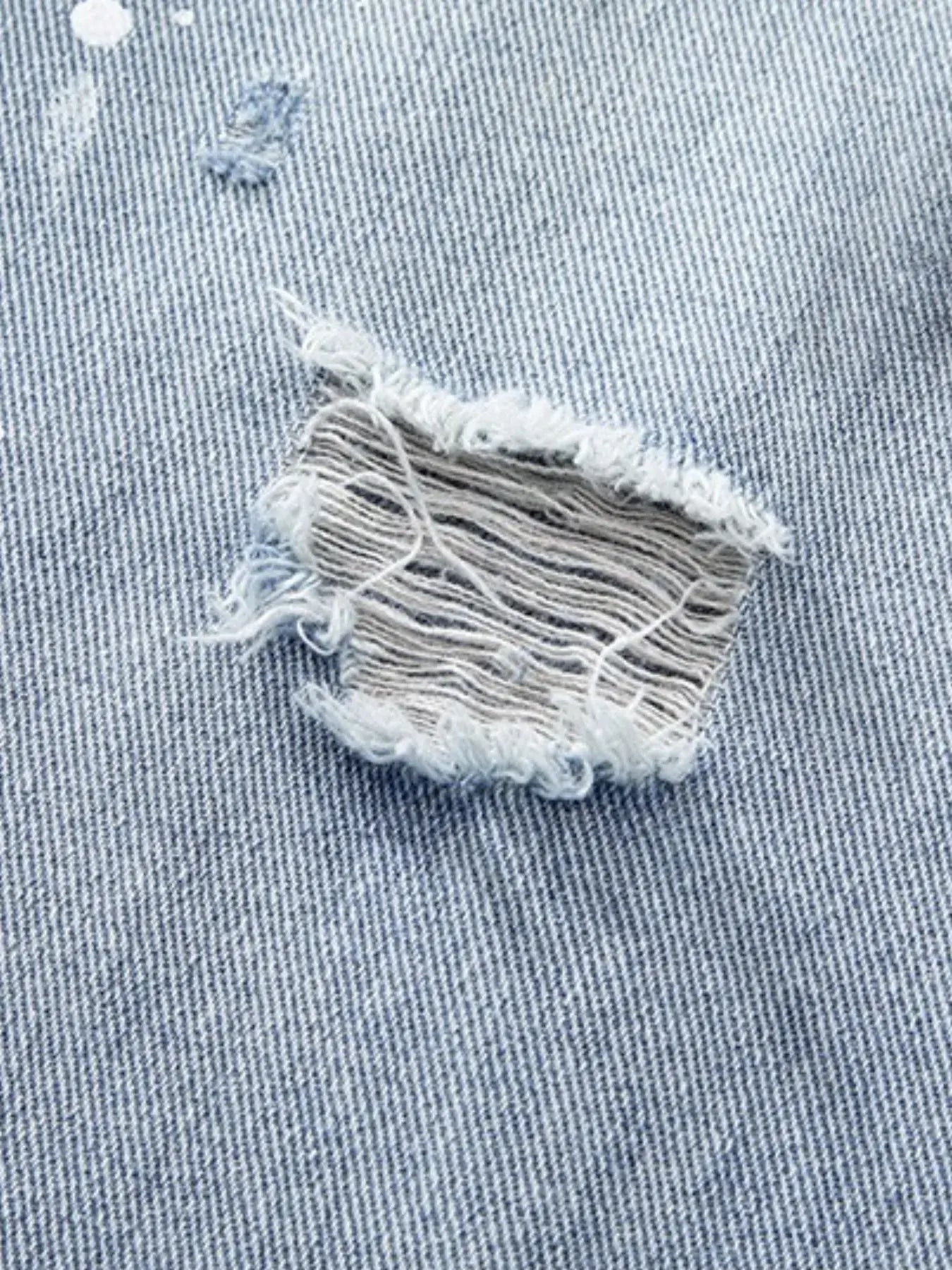 Light blue Luxenk distressed wide-leg jeans by Trendsi, featuring a relaxed fit and stylish ripped detailing.