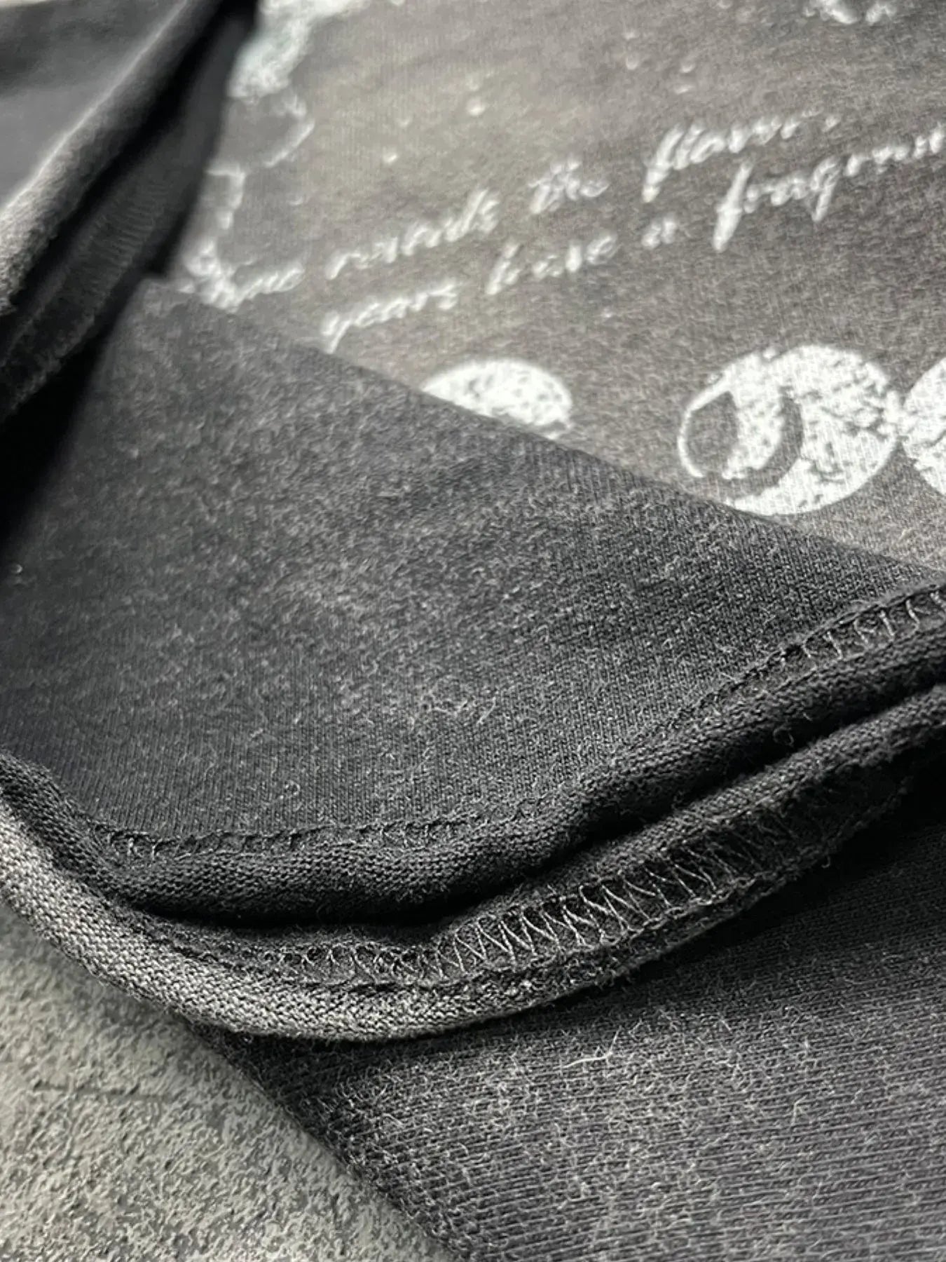 Black LUXENK Street Graphic T-shirt from Trendsi featuring spray dye design and casual fit, ideal for streetwear style.