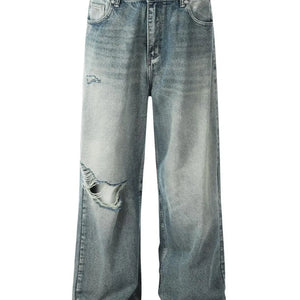 Washed blue distressed vintage jeans by Luxenk© featuring a slim fit and faded details, shown on a model.