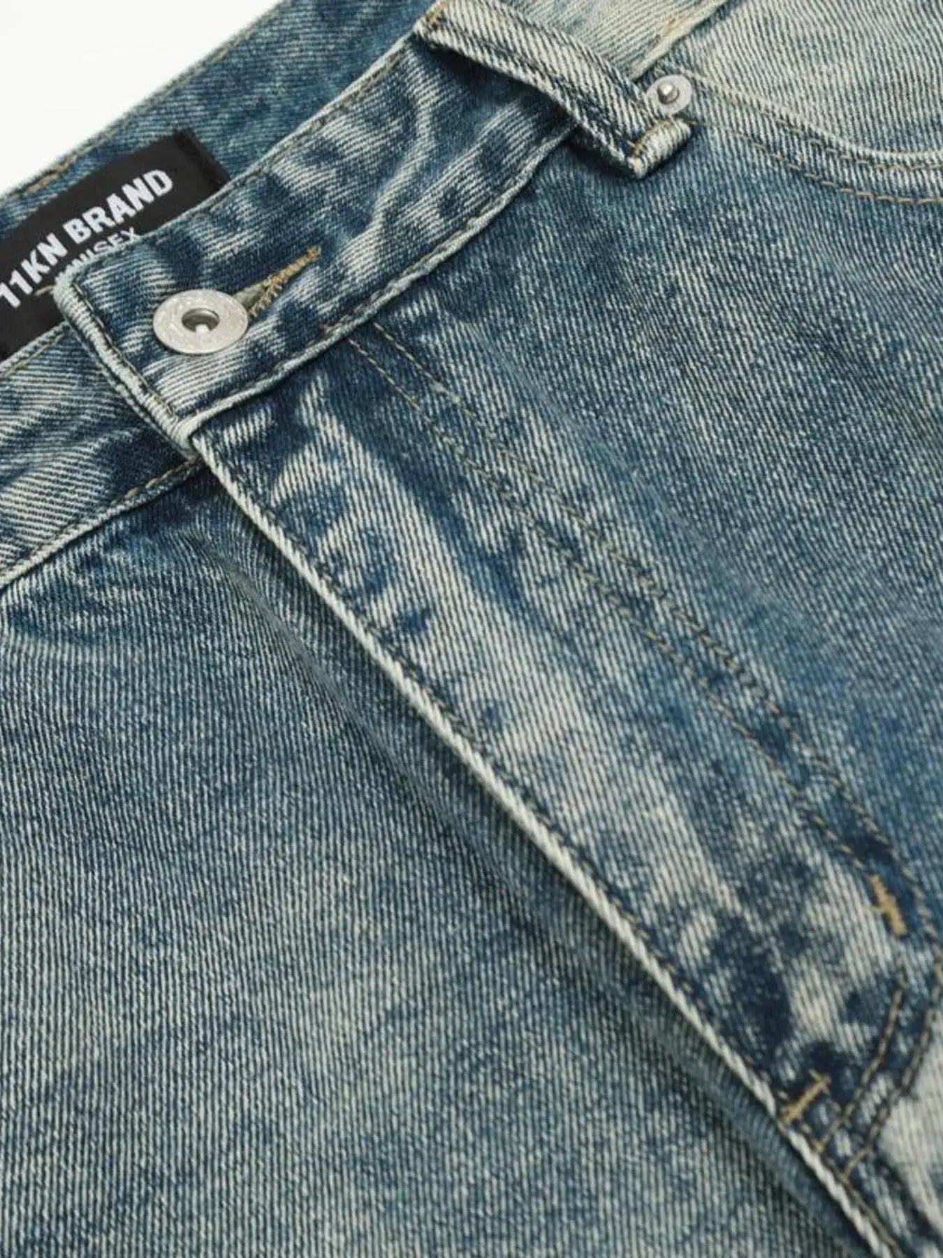 Washed blue distressed vintage jeans by Luxenk© featuring a slim fit and faded finish, styled with casual pockets and belt loops.