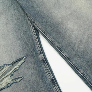 Washed blue distressed vintage jeans by Luxenk© featuring a relaxed fit and faded details, styled with casual wear.