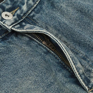 Light blue distressed vintage jeans by Luxenk, showing a relaxed fit and worn-in denim texture.