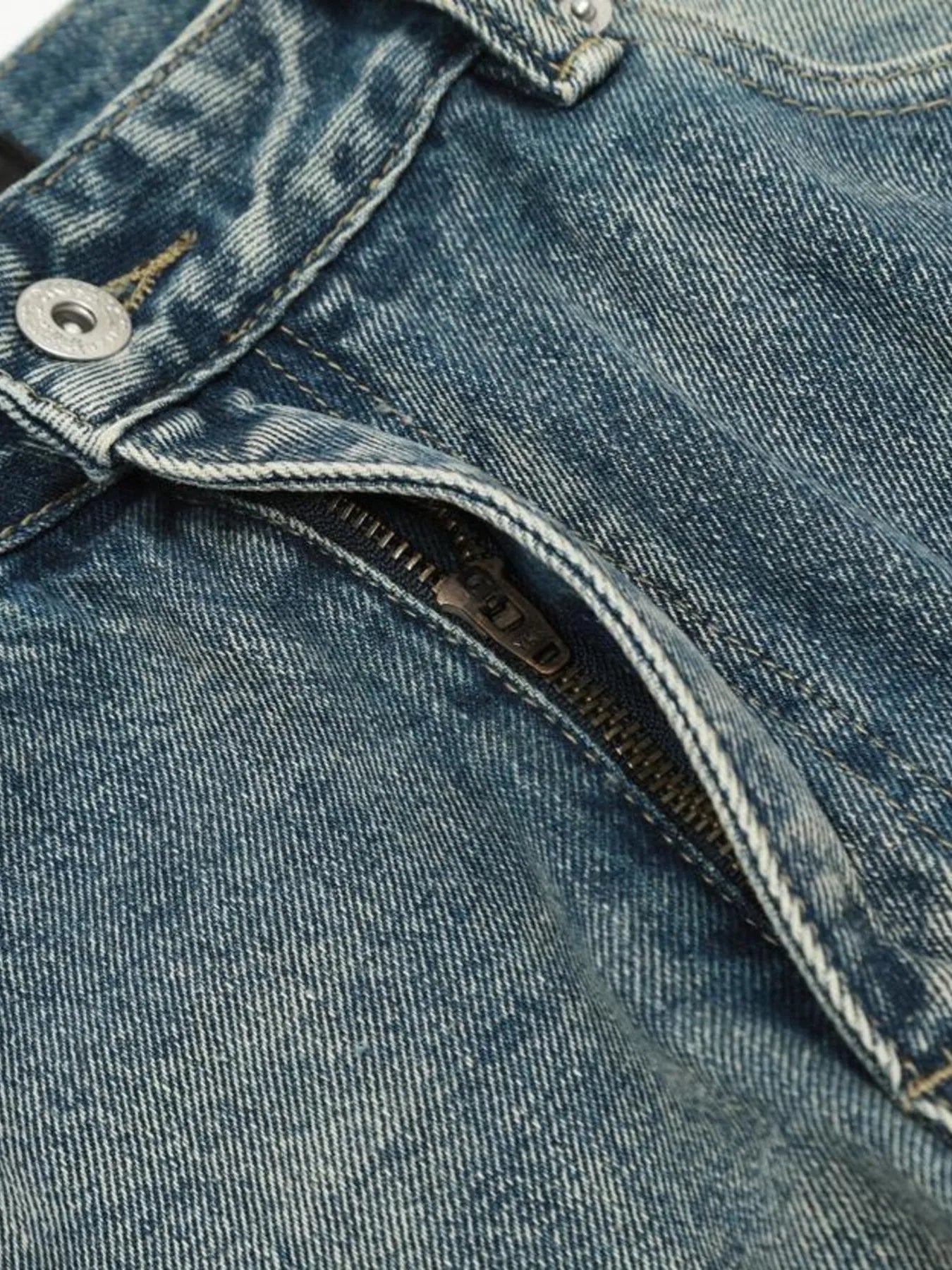 Light blue distressed vintage jeans by Luxenk, showing a relaxed fit and worn-in denim texture.