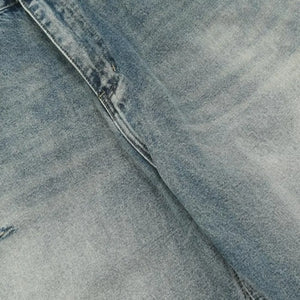 Washed blue distressed vintage jeans by LUXENK©, trendy slim-fit denim with frayed details and a casual, worn-in look.