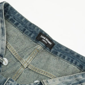 Washed blue distressed vintage LUXENK© jeans with a relaxed fit, featuring ripped details and a classic denim look.