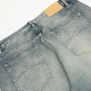 Washed blue distressed vintage LUXENK© jeans with frayed hems and fading, casual fit, shown on a model for trendy everyday wear.