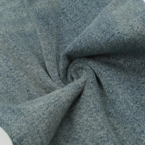 Washed blue distressed vintage jeans by Luxenk©, featuring a fitted style with ripped details and a casual, worn-in look.