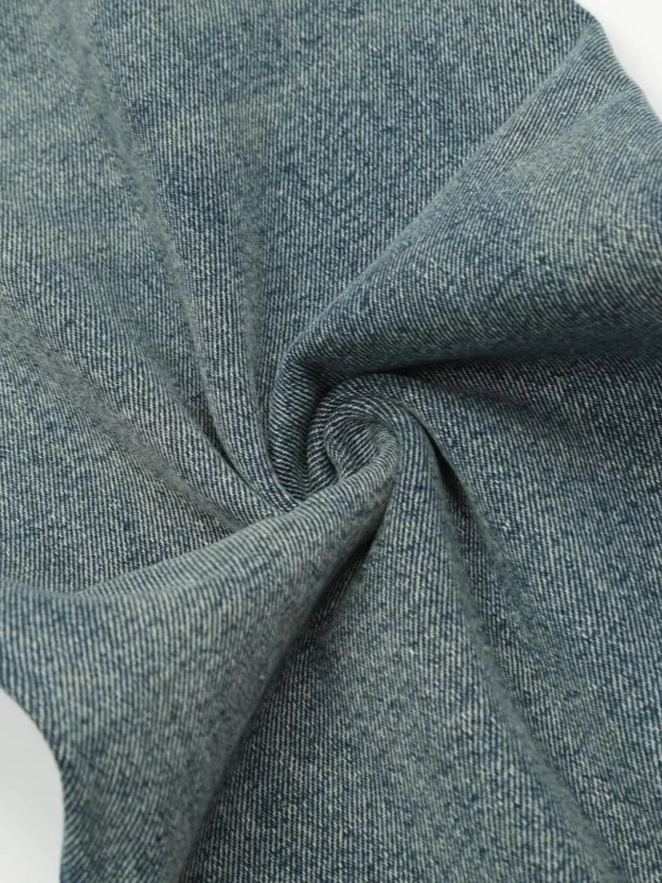 Washed blue distressed vintage jeans by Luxenk©, featuring a fitted style with ripped details and a casual, worn-in look.
