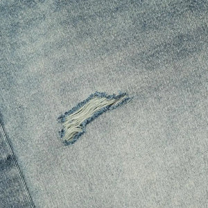Washed blue distressed vintage jeans by Luxenk for Trendsi, featuring a relaxed fit and frayed details.