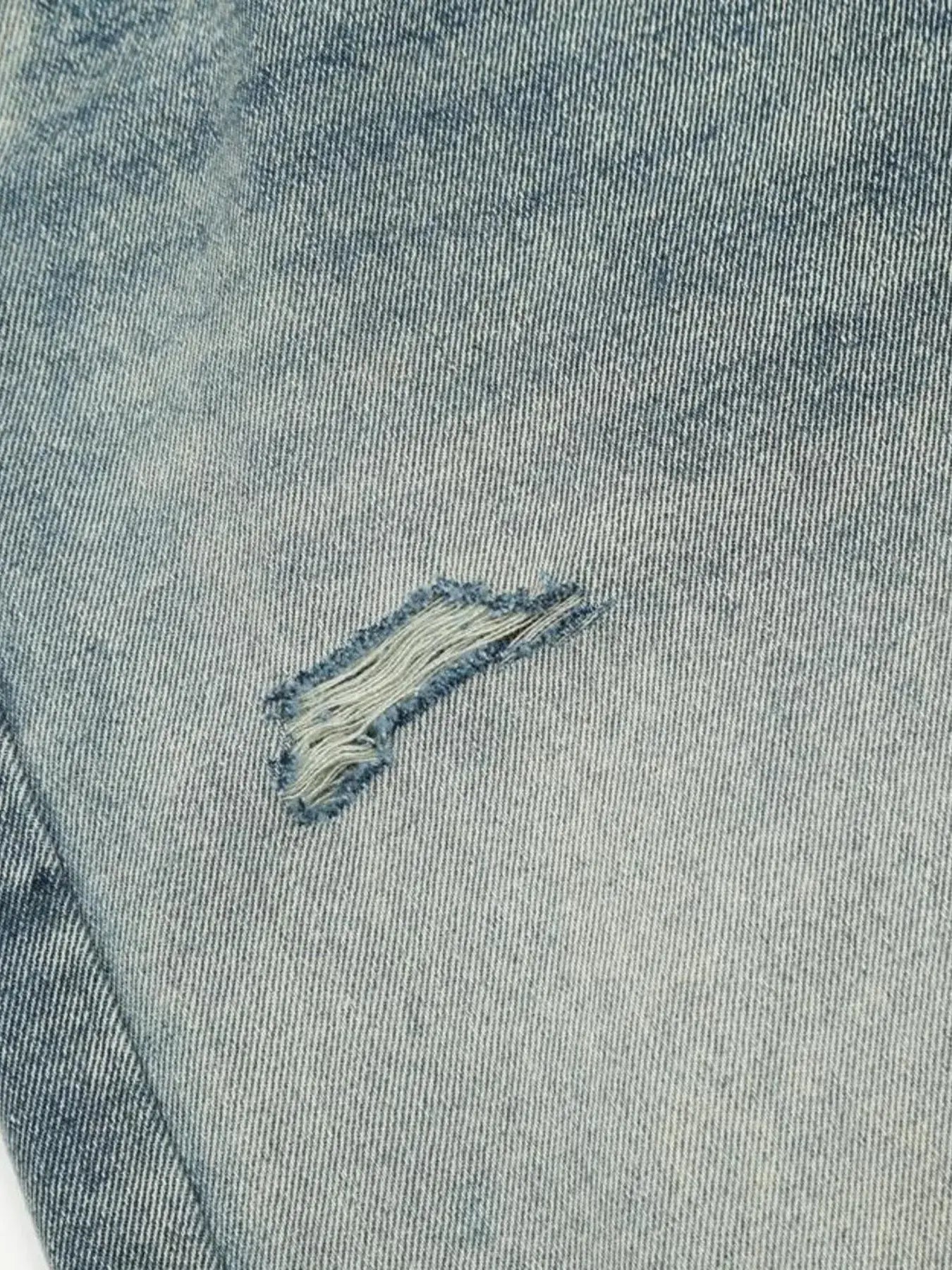 Washed blue distressed vintage jeans by Luxenk for Trendsi, featuring a relaxed fit and frayed details.