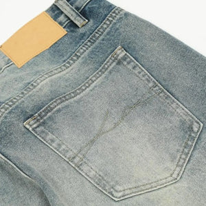 Washed blue distressed vintage jeans by Luxenk©, featuring a slim fit and faded details, displayed on a white background.