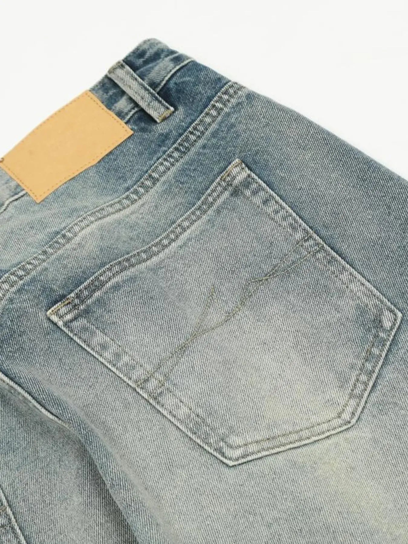 Washed blue distressed vintage jeans by Luxenk©, featuring a slim fit and faded details, displayed on a white background.
