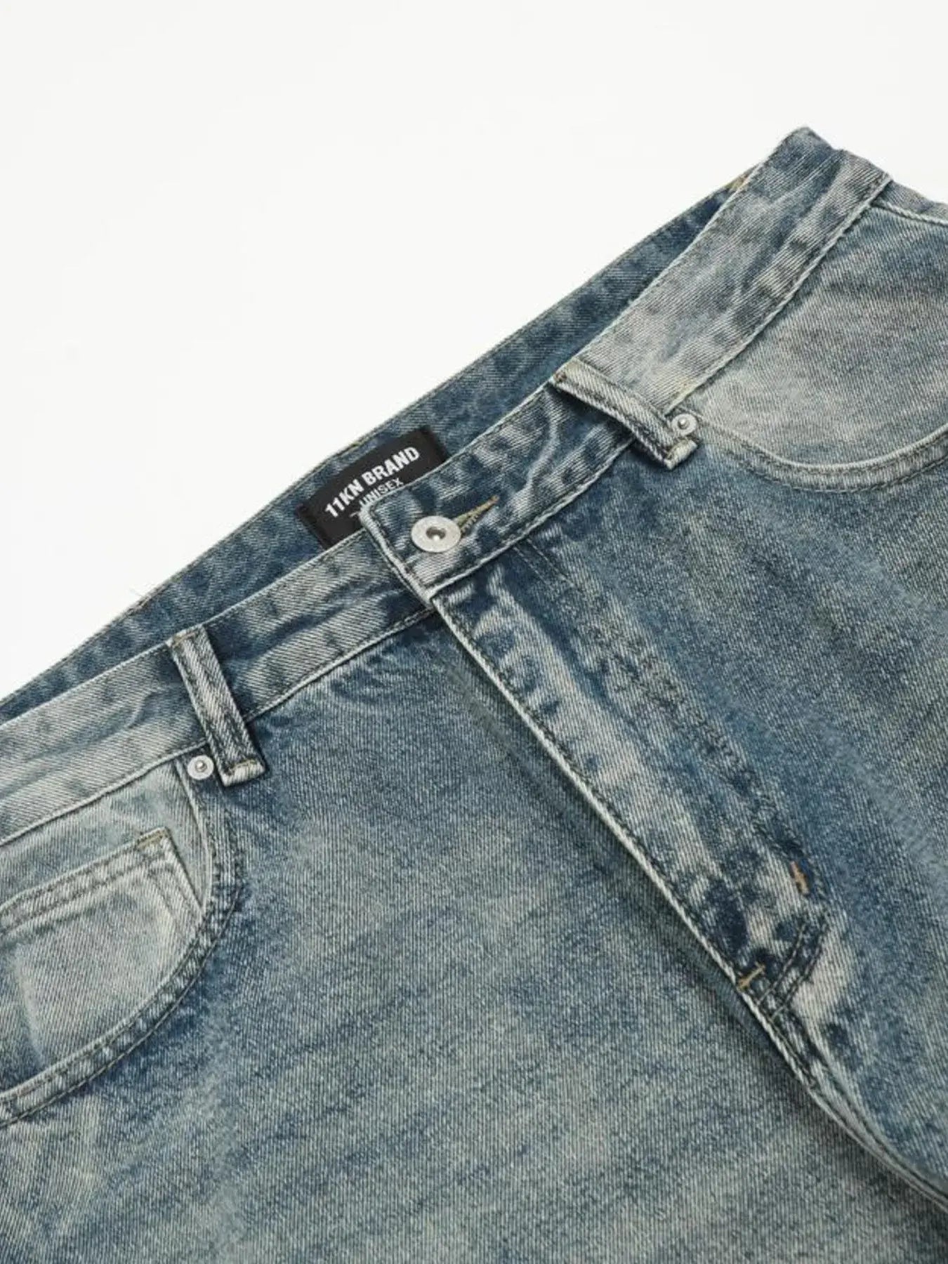 Washed blue distressed vintage jeans by Luxenk© featuring a slim fit and frayed hem, styled on a mannequin.
