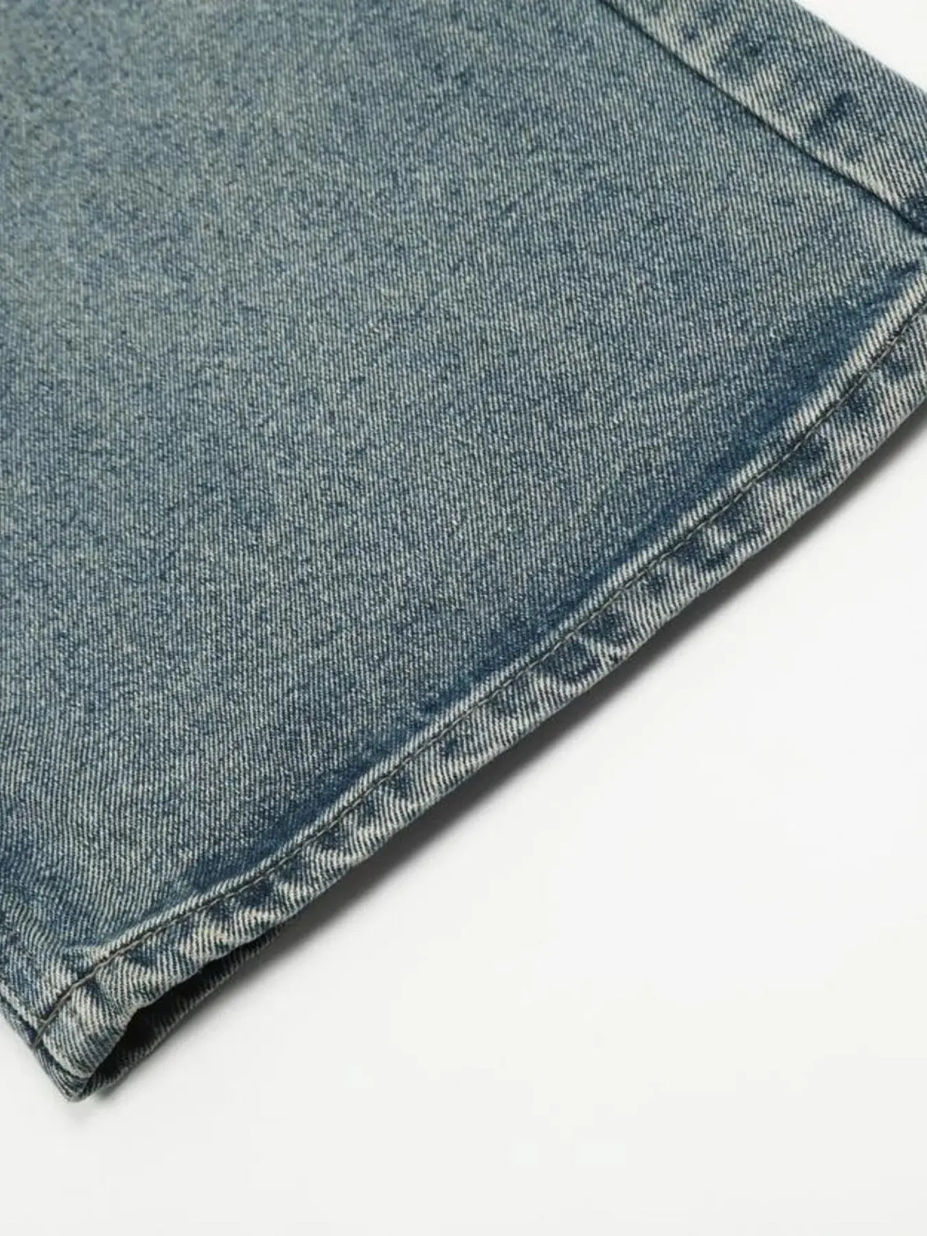 Washed blue distressed vintage LUXENK© jeans by Trendsi, showcasing a fitted skinny style with intentional fading and rips.