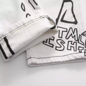 White Luxenk Graffiti Slim Jeans by Trendsi, showcasing a slim fit design with subtle graffiti-style detailing visible in the image.